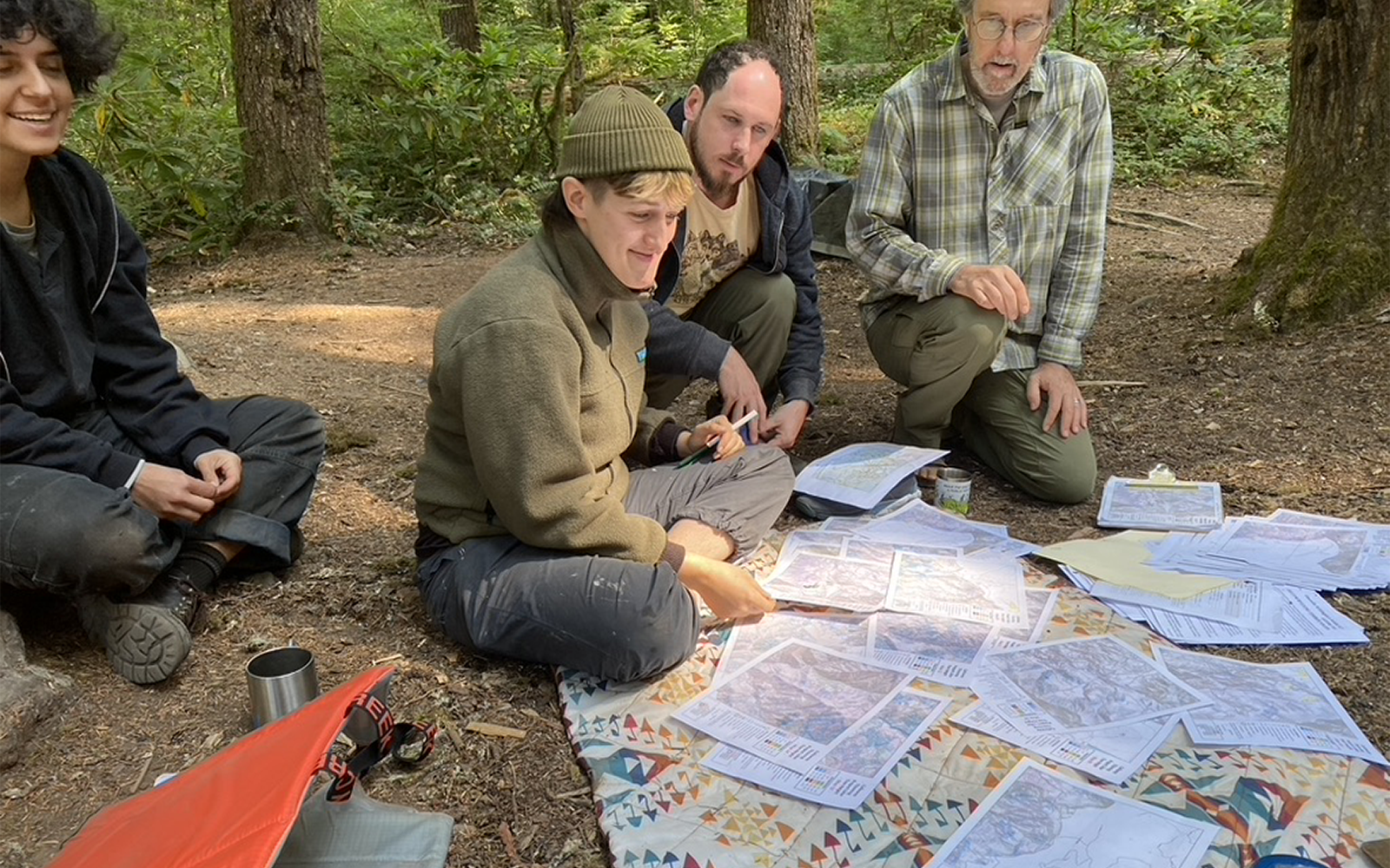 WildCATs looking over maps for the Calloway Timber Sale during the summer 2023 Basecamp (photo by Cascadia Wildlands).